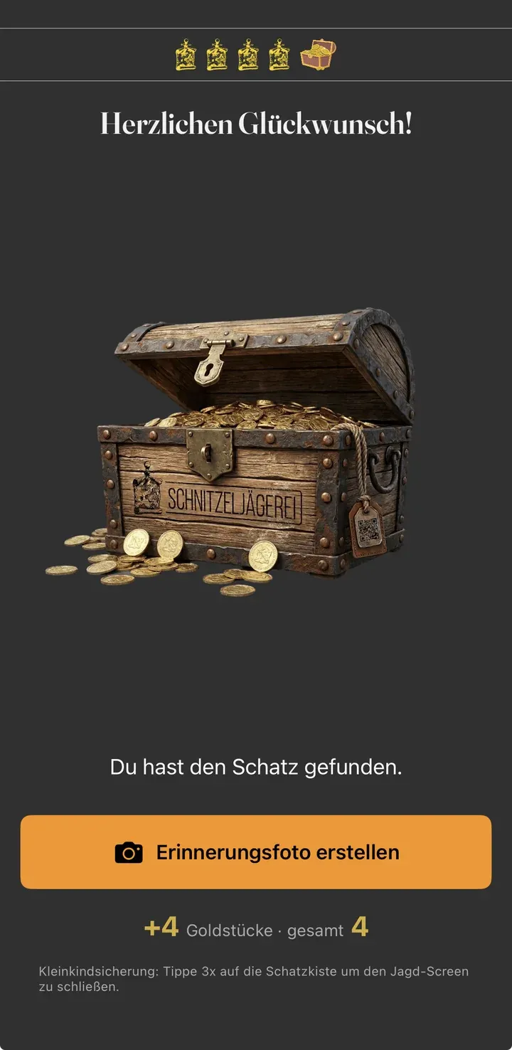 Erfolgs-Screen mit offener Schatztruhe, „Herzlichen Glückwunsch“ und der Gutschrift von vier Goldstücken